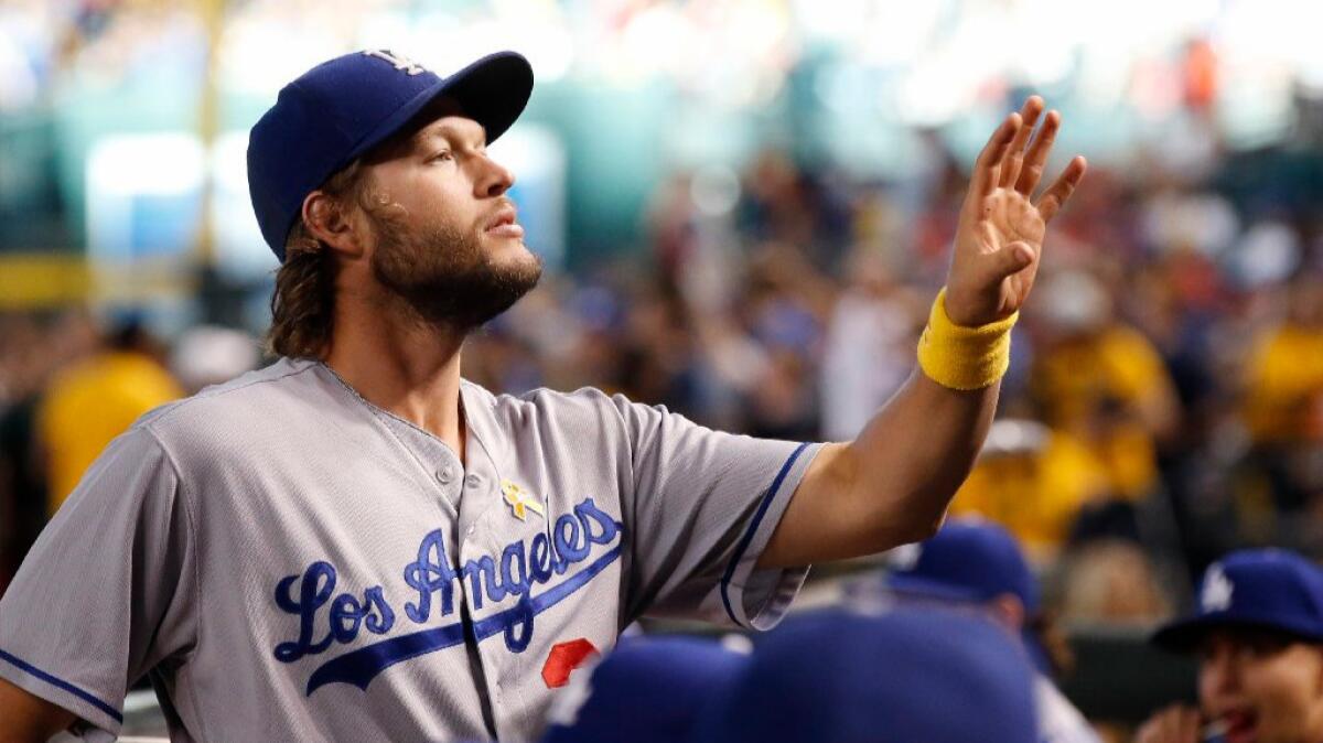 Dodgers ace Clayton Kershaw waits for a ball as he signs autographs before a game against the Diamondbacks on Sept. 17.