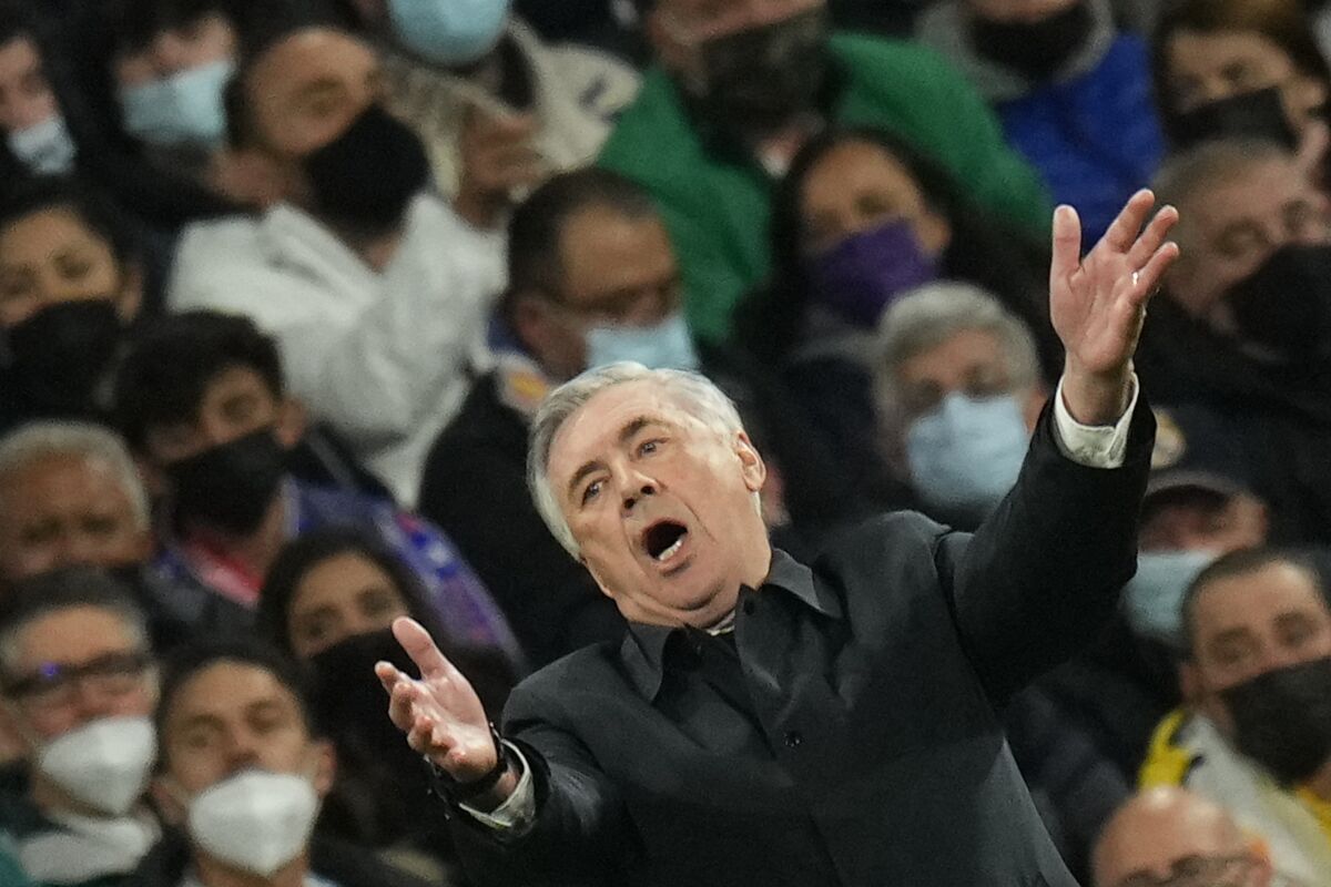 Real Madrid's head coach Carlo Ancelotti gestures during the Champions League, round of 16, second leg soccer match between Real Madrid and Paris Saint-Germain at the Santiago Bernabeu stadium in Madrid, Spain, Wednesday, March 9, 2022. (AP Photo/Manu Fernandez)
