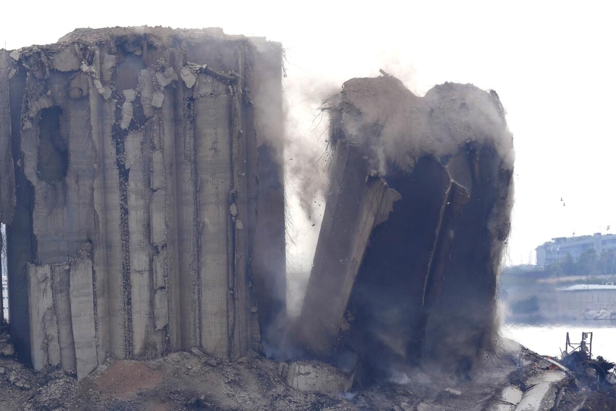A left part of the silos damaged during the August 2020 massive explosion in the port collapses, in Beirut, Lebanon,in Beirut, Lebanon, Thursday, Aug. 4, 2022. (AP Photo/Hussein Malla)