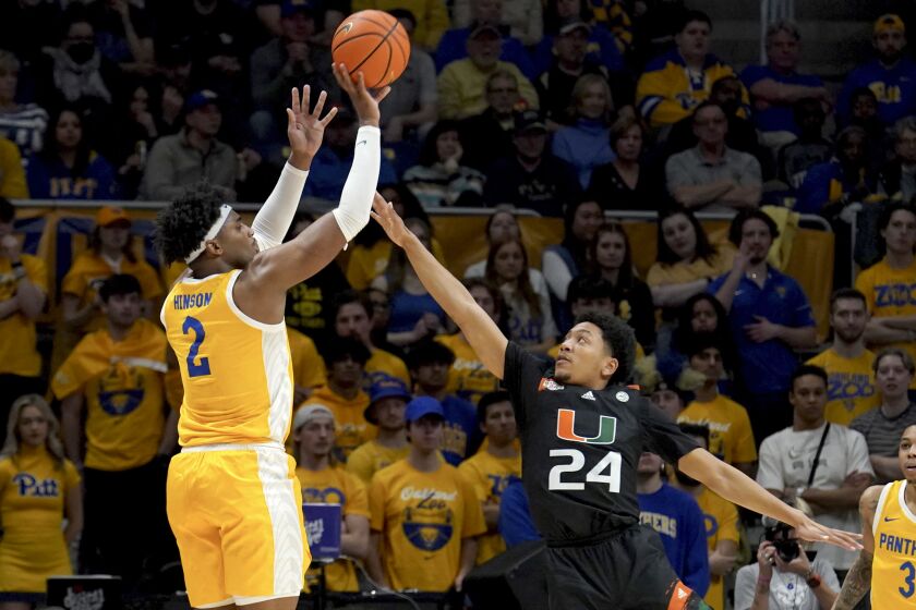 Pittsburgh forward Blake Hinson (2) puts up a shot against Miami guard Nijel Pack (24) during the first half of an NCAA college basketball game in Pittsburgh, Saturday, Jan. 28, 2023. (AP Photo/Matt Freed)