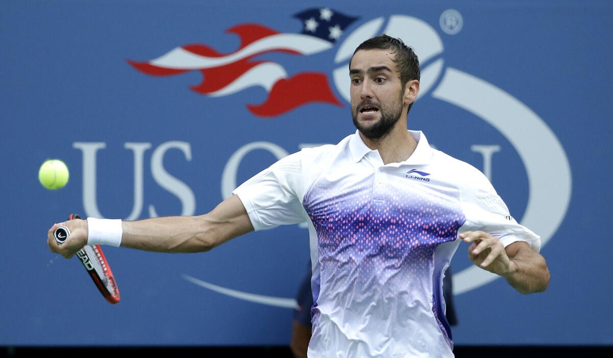 Marin Cilic returns a shot to Jo-Wilfried Tsonga during a quarterfinal match at the U.S. Open on Tuesday.