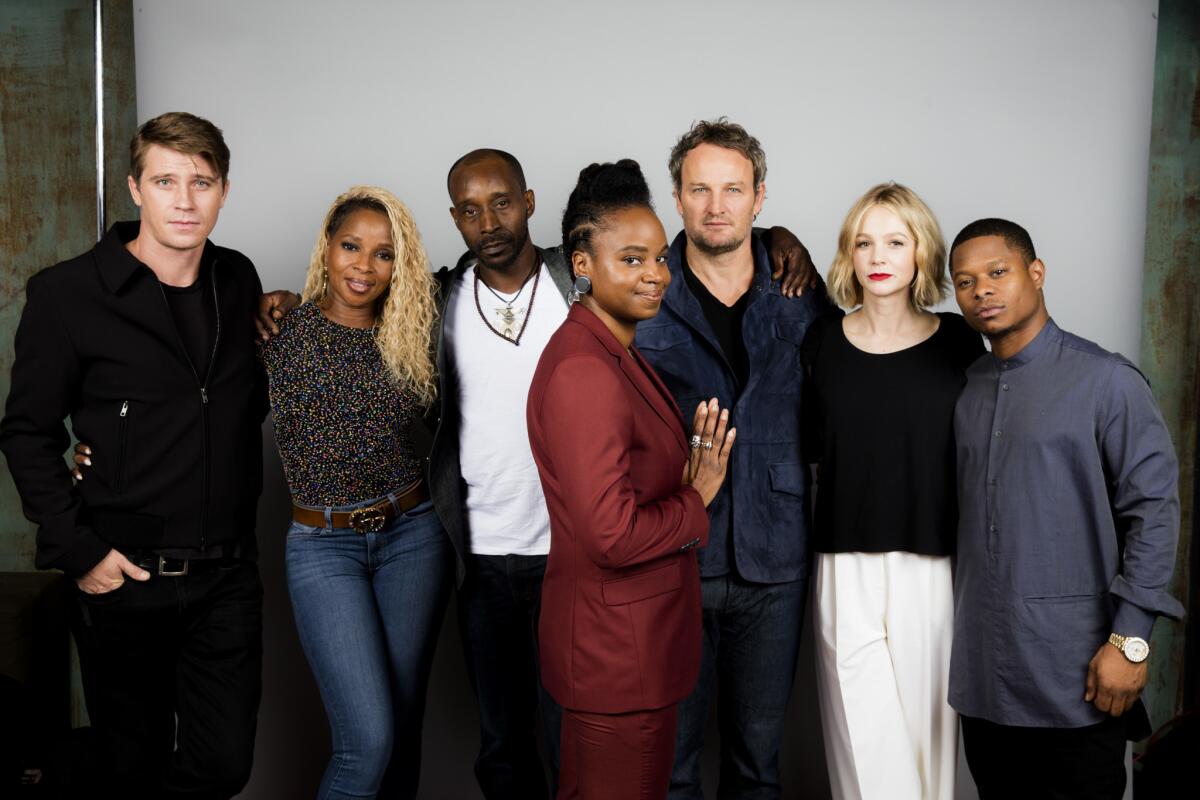 Garrett Hedlund, from left, Mary J. Blige, Rob Morgan, director Dee Rees, actor Jason Clarke, Carey Mulligan and Jason Mitchell from the film "Mudbound."