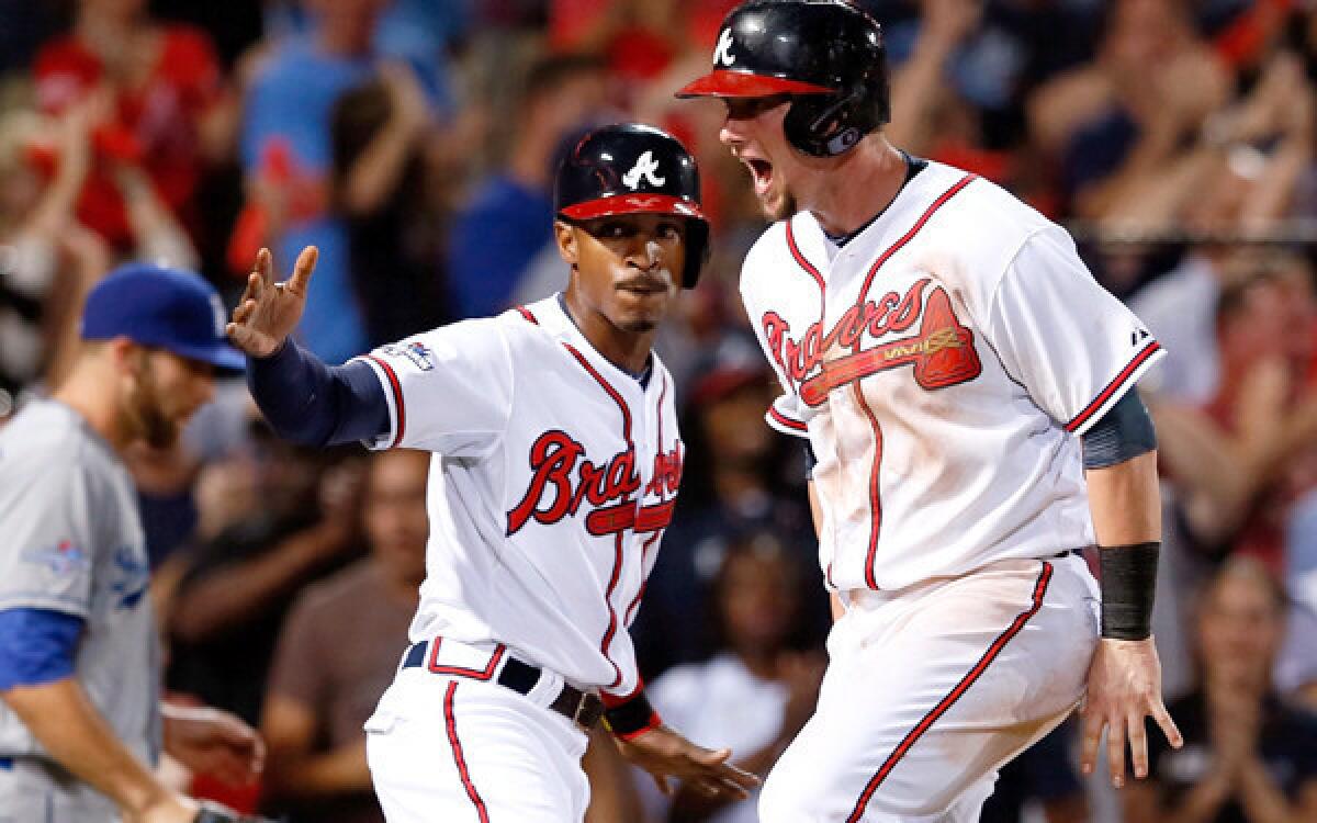 Braves players B.J. Upton, left, and Chris Johnson had plenty to celebrate with a Game 2 victory on Friday night. TBS announcers had to be pleased with the outcome, too.