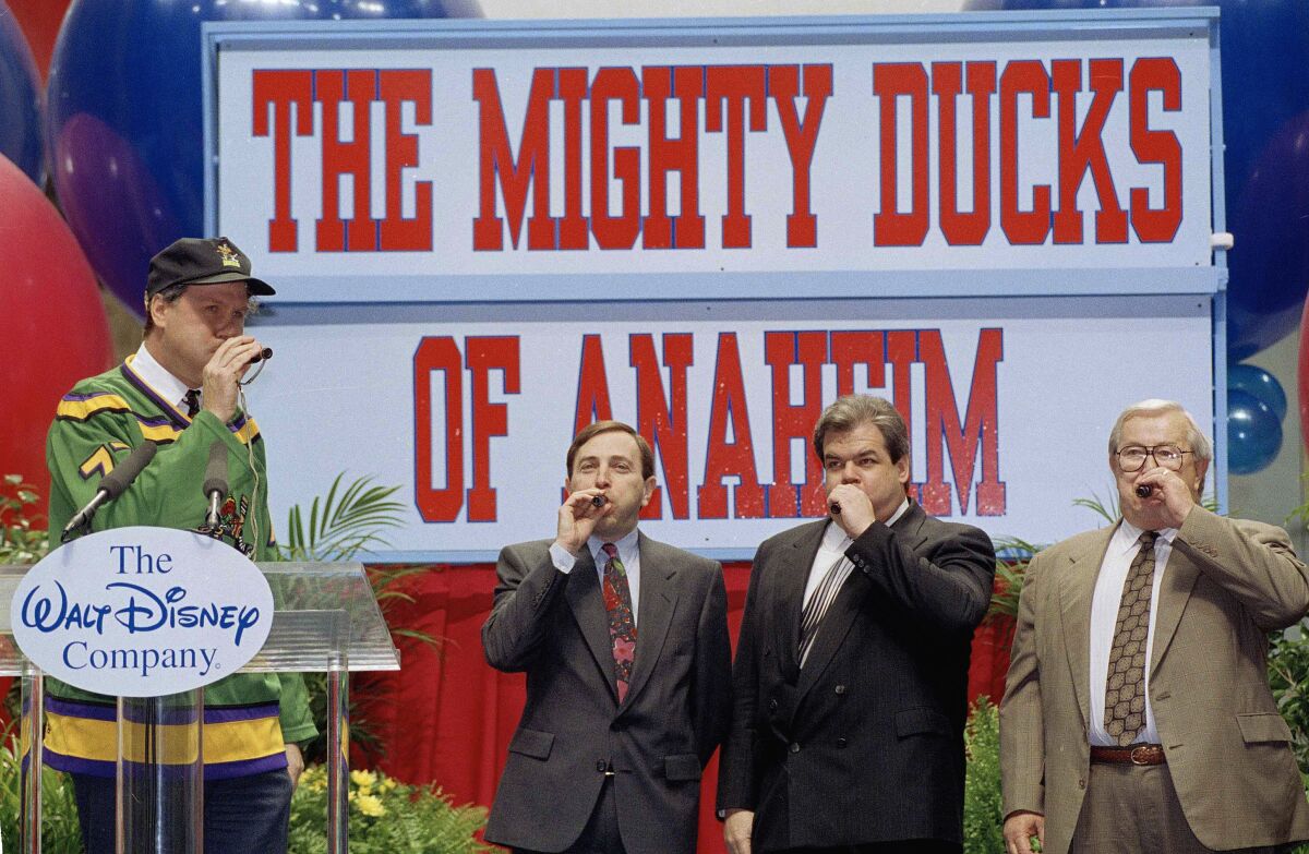 NHL Commissioner Gary Bettman blows on a duck call with Michael Eisner, Bruce McNall and Jack Lindquist.