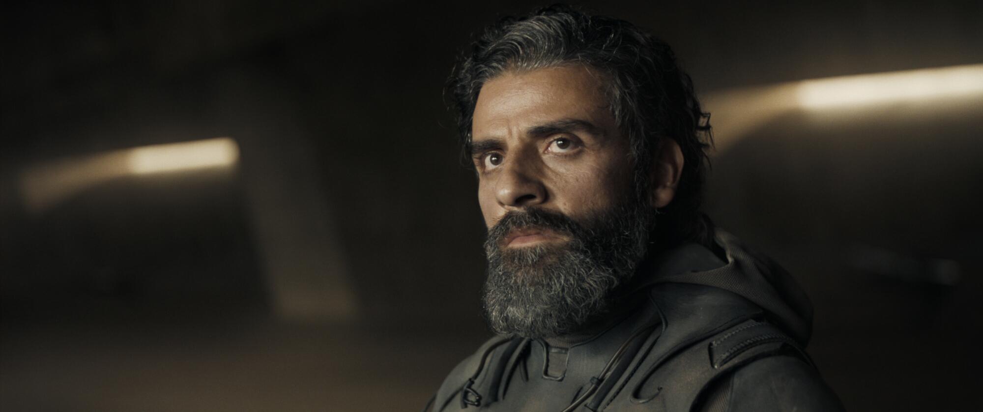 A bearded OSCAR ISAAC in “DUNE”