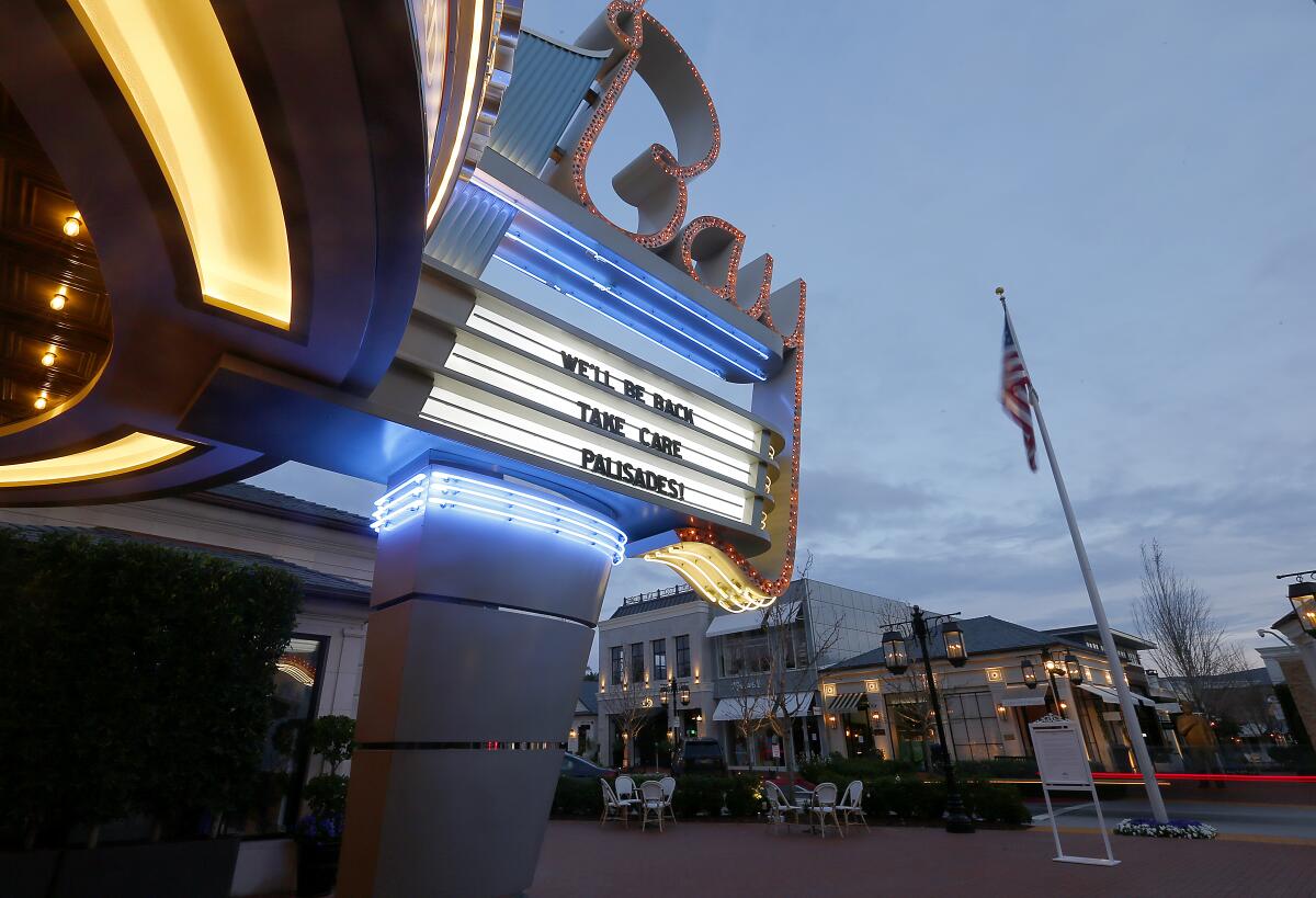 Palisades Village theater sign saying 'We'll be back'