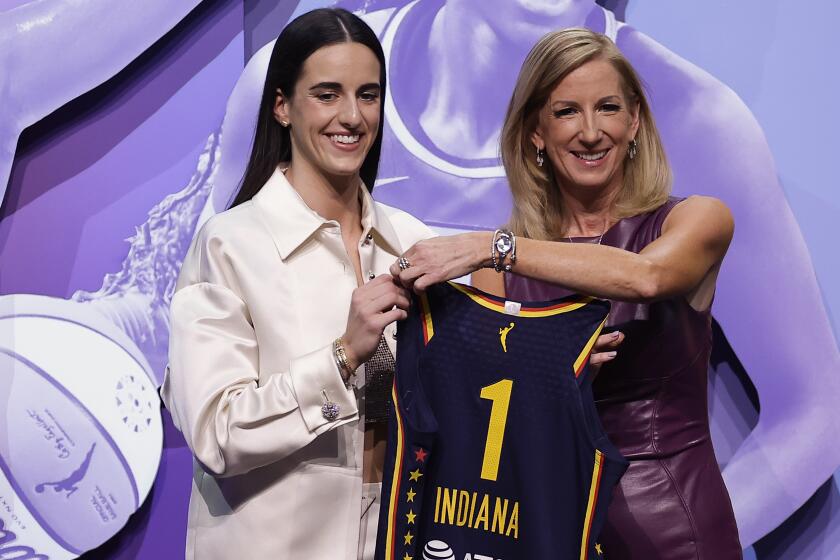 Iowa's Caitlyn Clark, left, poses for a photo with WNBA commissioner Cathy Engelbert 