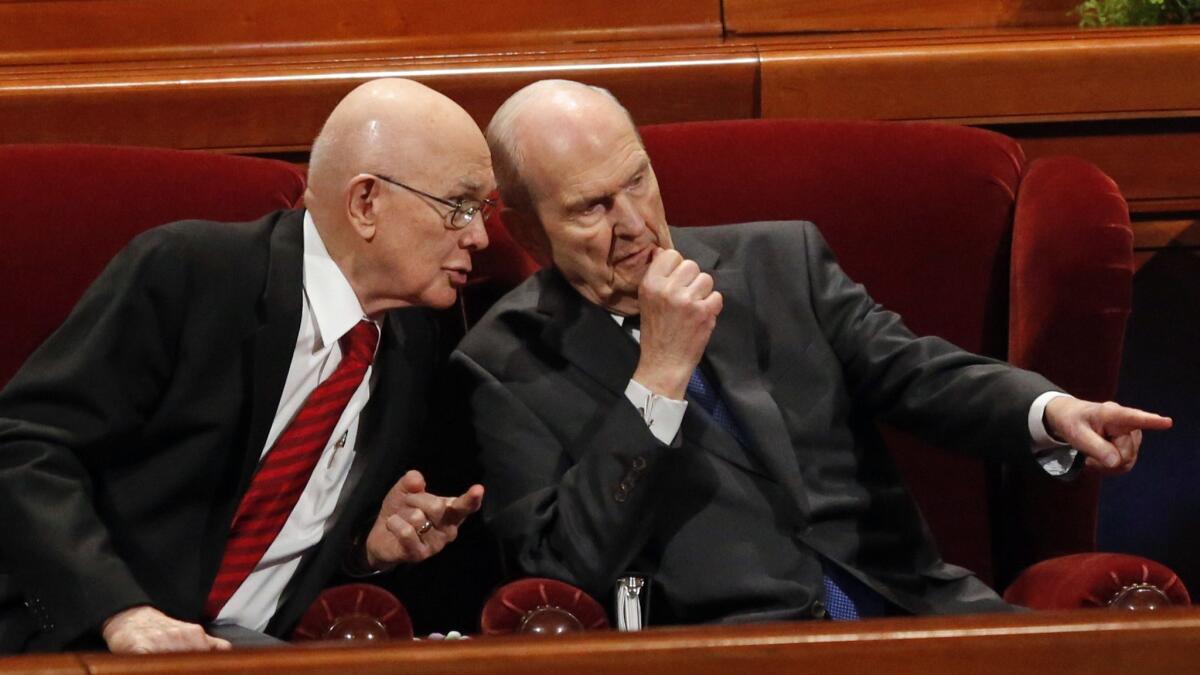 Counselor Dallin H. Oaks, left, speaks with Russell M. Nelson, president of the Church of Jesus Christ of Latter-day Saints, during the church's conference on Saturday in Salt Lake City.