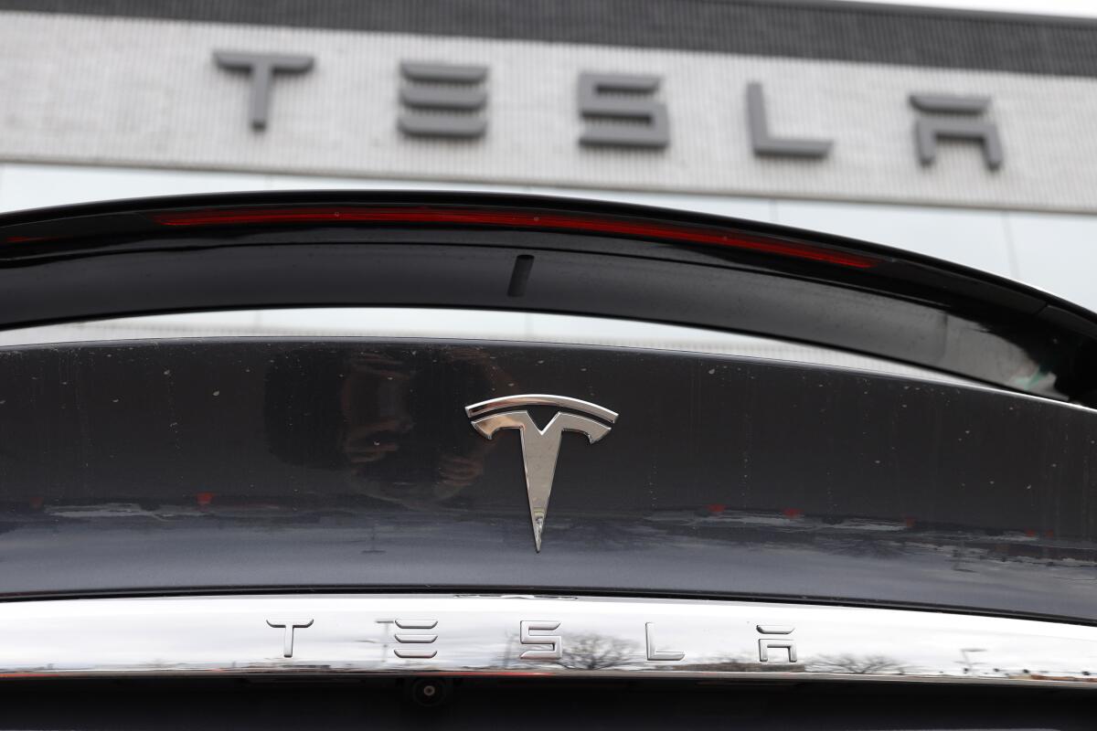 A closeup of the Tesla logo on the rear deck a 2020 Model X