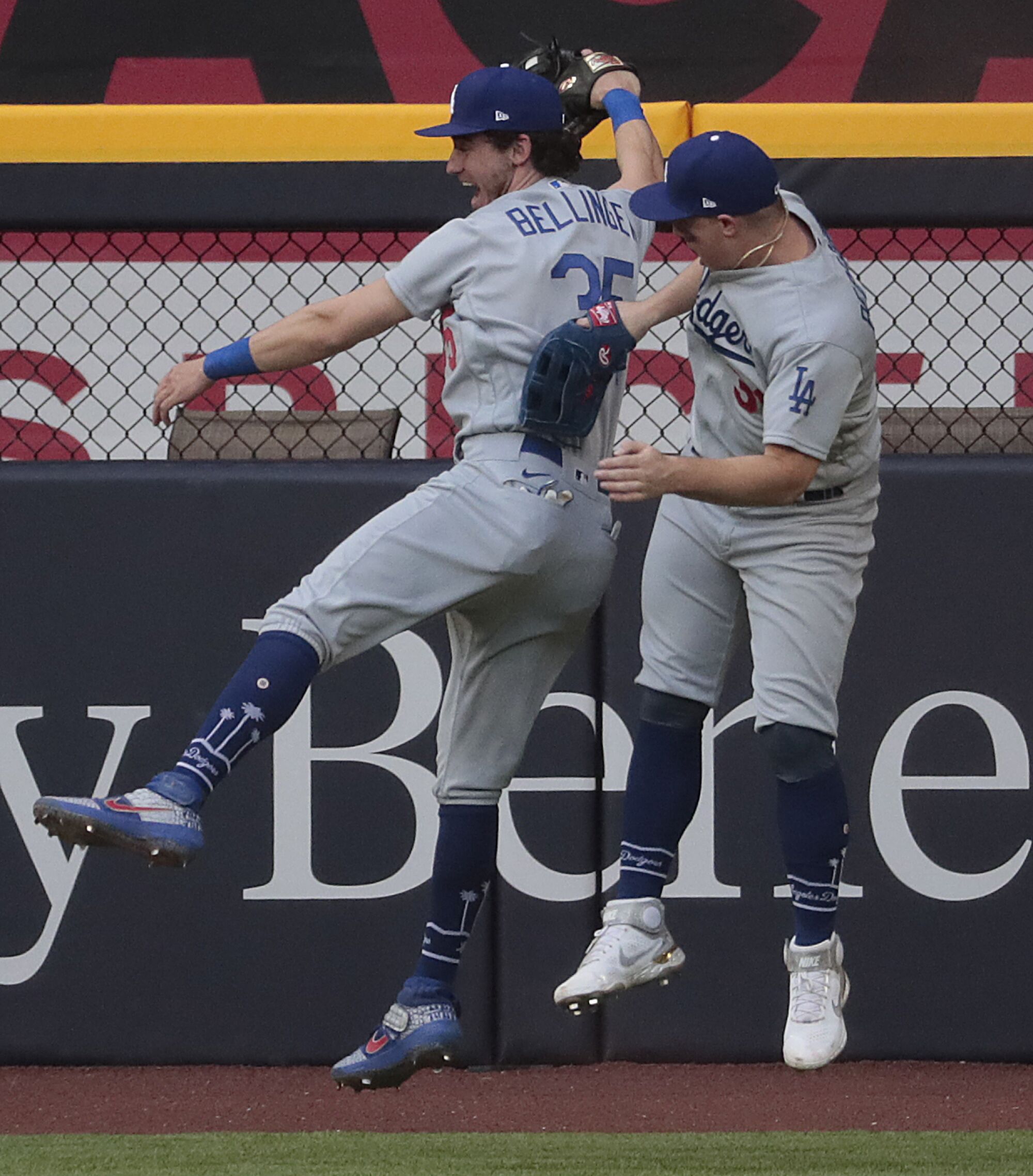 Dodgers center fielder Cody Bellinger, left, celebrates with left fielder Joc Pederson after making a leaping catch.