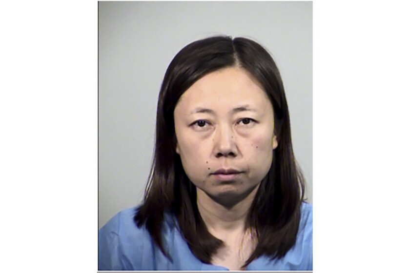 This Saturday, May 15, 2021, booking photo released by Tempe Police Department shows Yui Inoue, 40, who is jailed for allegedly killing her two children in Temple, Ariz. Yui Inoue remained jailed on suspicion of two counts of first-degree murder, according to Tempe police. It was unclear Sunday if Inoue has a lawyer yet. Police said the woman primarily speaks Japanese and had an interpreter for a post-Miranda interview. Inoue drove to a police station about 7 a.m. Saturday and told officers she was hearing voices telling her to kill her children, authorities said. (Tempe Police Department via AP)