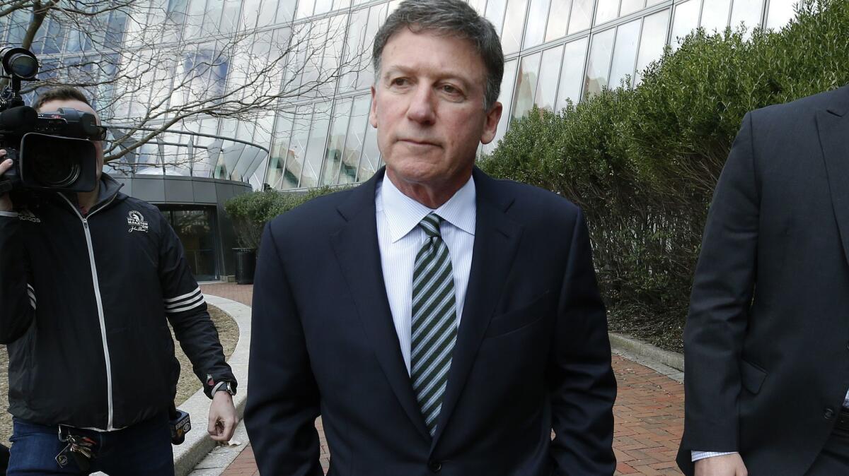 Bruce Isackson of Hillsborough, Calif., departs federal court on April 3 in Boston after facing charges in a nationwide college admissions bribery scandal.