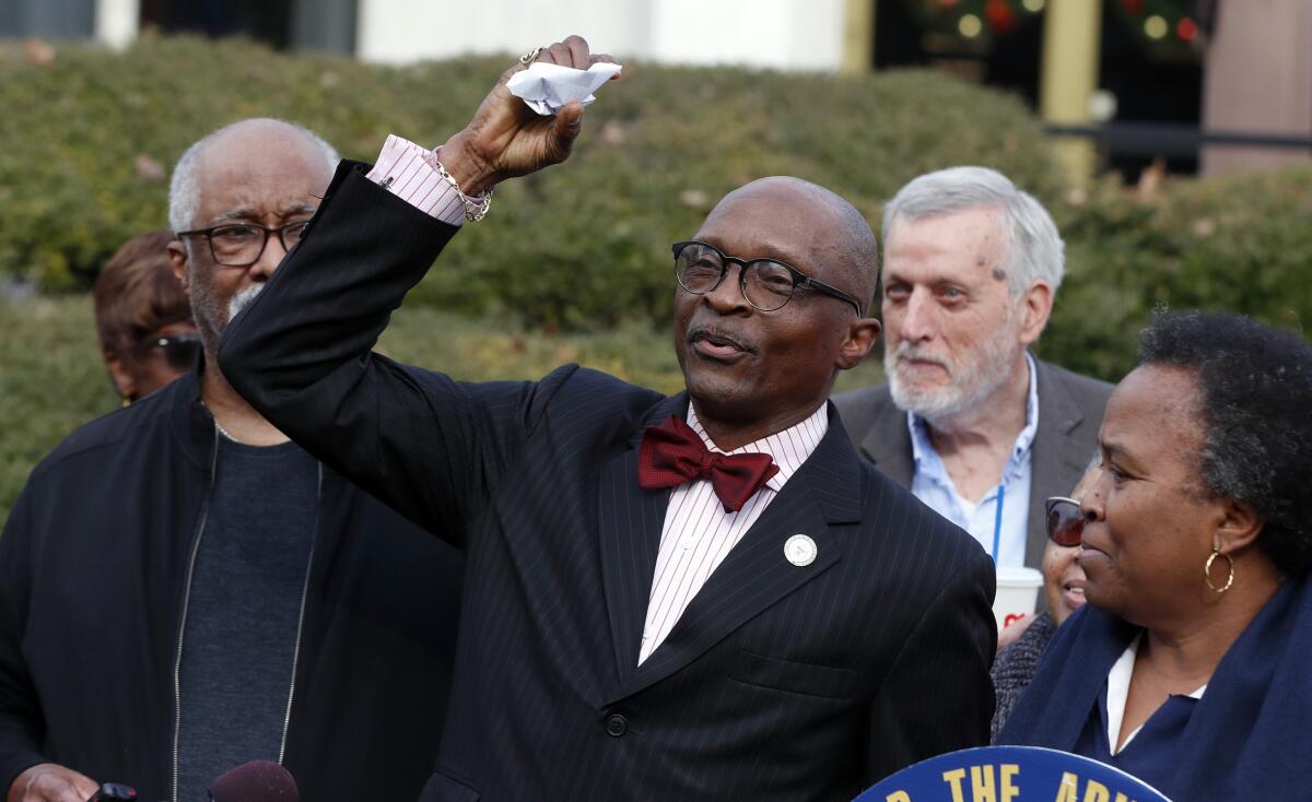 FILE - The Rev. T. Anthony Spearman, then-president of the North Carolina NAACP, crumples up a mailer which tells voters that IDs are needed in the upcoming 2020 election during a news conference outside the Legislative Building in Raleigh, N.C., on Dec. 27, 2019. Spearman, a civil rights advocate and former president of the N.C., branch of the NAACP who also served as president of the N.C. Council of Churches, has been found dead, his attorney said Wednesday, July 20, 2022. (Ethan Hyman/The News & Observer via AP, File)/The News & Observer via AP)