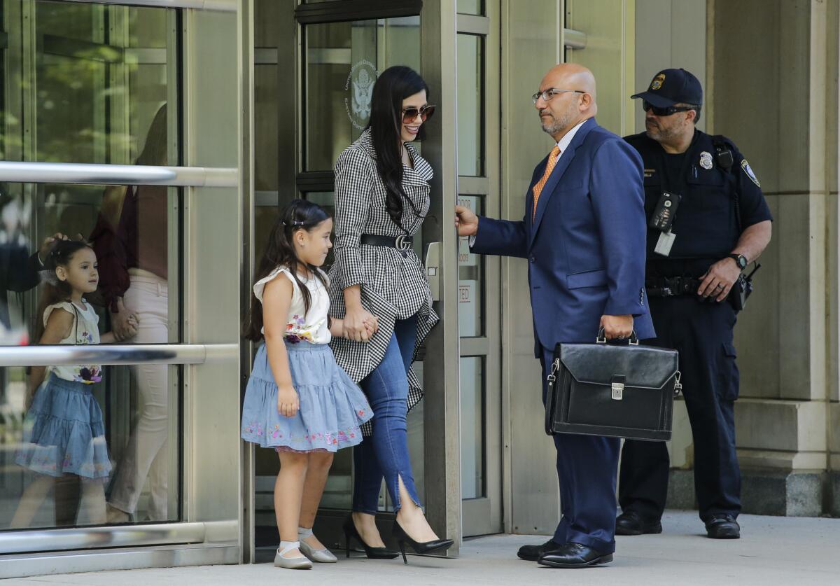 Emma Coronel, wife of Joaquin "El Chapo" Guzman, leaves federal court in Brooklyn, N.Y., with her twin daughters after a hearing in the case of her husband on June 26.