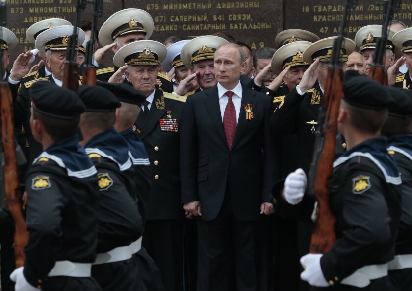 Russian President Vladimir Putin is seen being honored in this file photo from the May 9, 2014, Victory Day celebrations in Sevastopol, Crimea, home of Russia's Black Sea fleet.