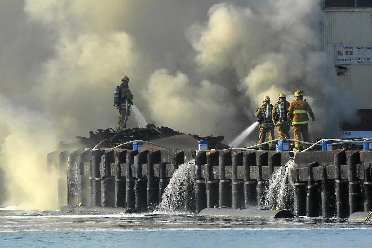 Los Angeles fire crews battle a fire at the Port of L.A. that burned lumber soaked in creosote, releasing toxic chemicals into the air.