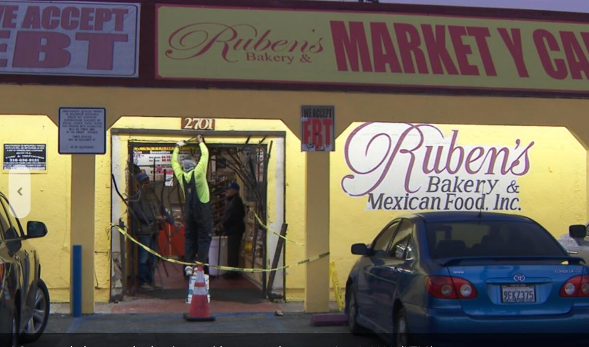 The front of a market is painted yellow with a sign that says "Ruben's Bakery & Mexican Food, Inc."