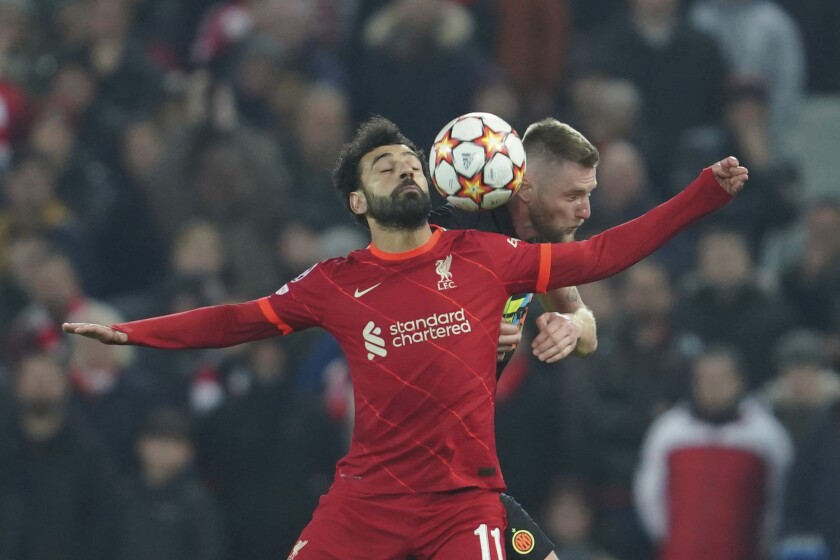 Liverpool's Mohamed Salah, left, fights for the ball with Inter Milan's Milan Skriniar during the Champions League, round of 16, second leg soccer match between Liverpool and Inter Milan at Anfield stadium in Liverpool, England, Tuesday, March 8, 2022. (AP Photo/Jon Super)