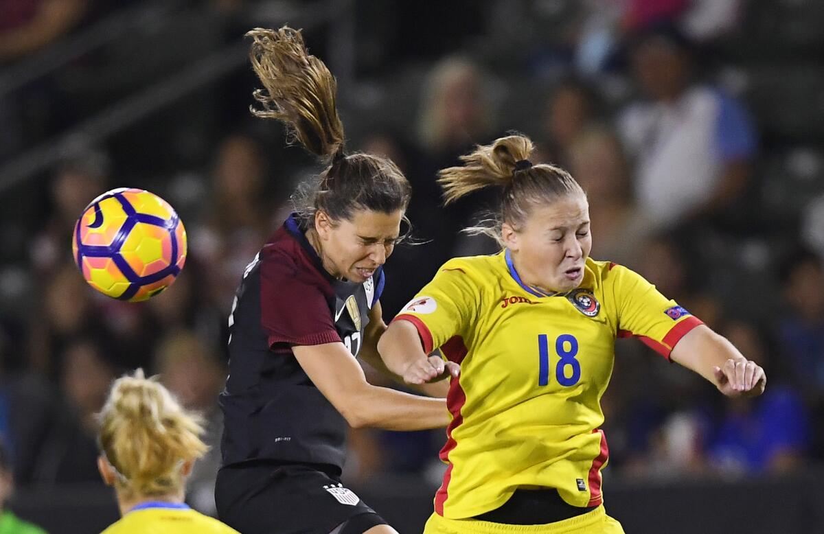 United States midfielder Tobin Heath, left, and Romania forward Mihaela Ciolacu try to head the ball during the first half of an exhibition soccer match, Sunday, Nov. 13, 2016, in Carson, Calif. (AP Photo/Mark J. Terrill)