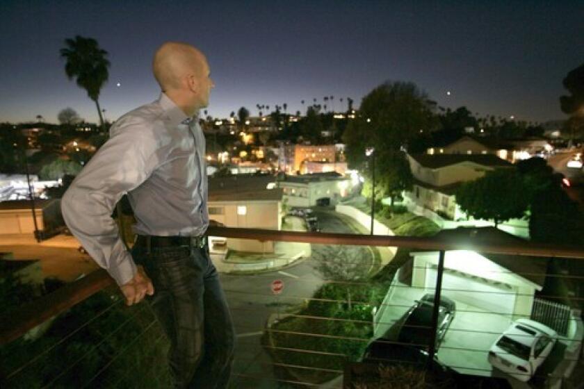 Tim Campbell checks out the view from outdoor deck of his four-story home on Hamilton Way in Silverlake.