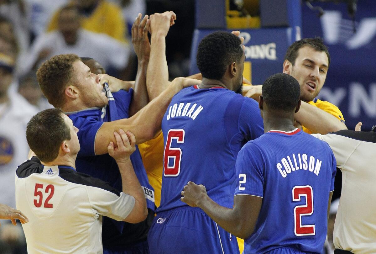 Warriors center Andrew Bogut, right, and Clippers power forward Blake Griffin are separated after getting into an altercation in the fourth quarter Wednesday night in Oakland.