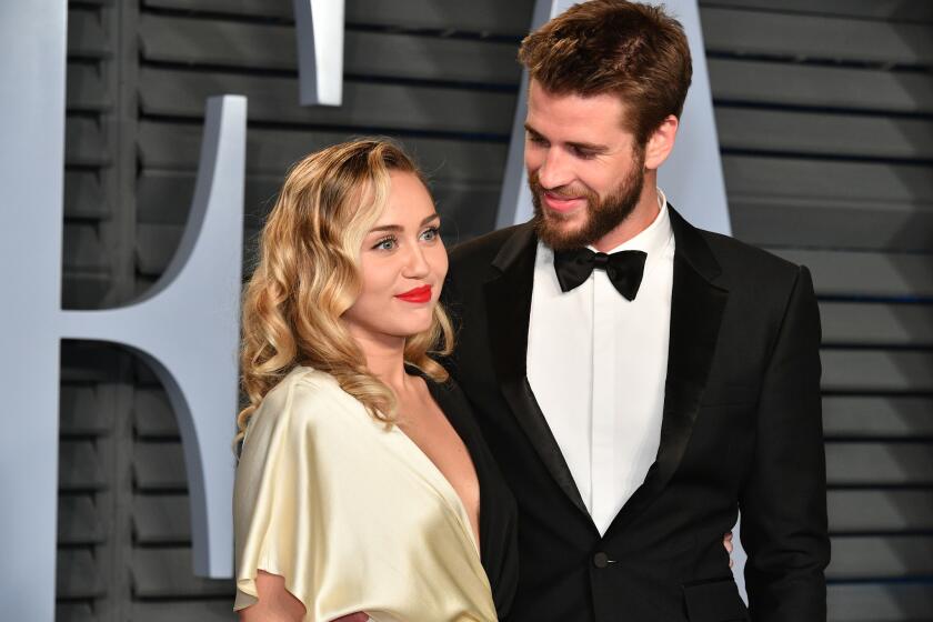 FILE: Singer/actor Miley Cyrus and actor Liam Hemsworth have married, according to posts on their social media accounts. BEVERLY HILLS, CA - MARCH 04: Miley Cyrus (L) and Liam Hemsworth attend the 2018 Vanity Fair Oscar Party hosted by Radhika Jones at Wallis Annenberg Center for the Performing Arts on March 4, 2018 in Beverly Hills, California. (Photo by Dia Dipasupil/Getty Images) ** OUTS - ELSENT, FPG, CM - OUTS * NM, PH, VA if sourced by CT, LA or MoD **