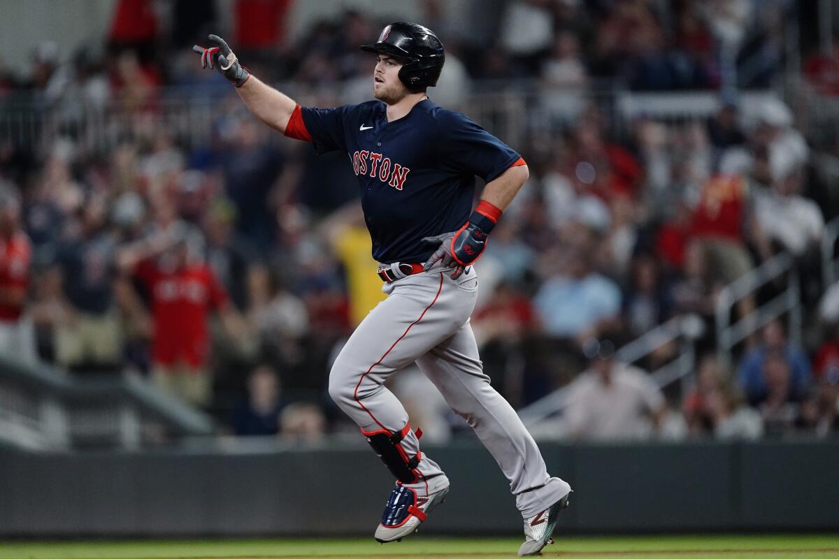 Boston Red Sox's Christian Arroyo (39) gestures as he rounds the bases after hitting a grand slam during the seventh inning of the team's baseball game against the Atlanta Braves on Wednesday, June 16, 2021, in Atlanta. (AP Photo/John Bazemore)