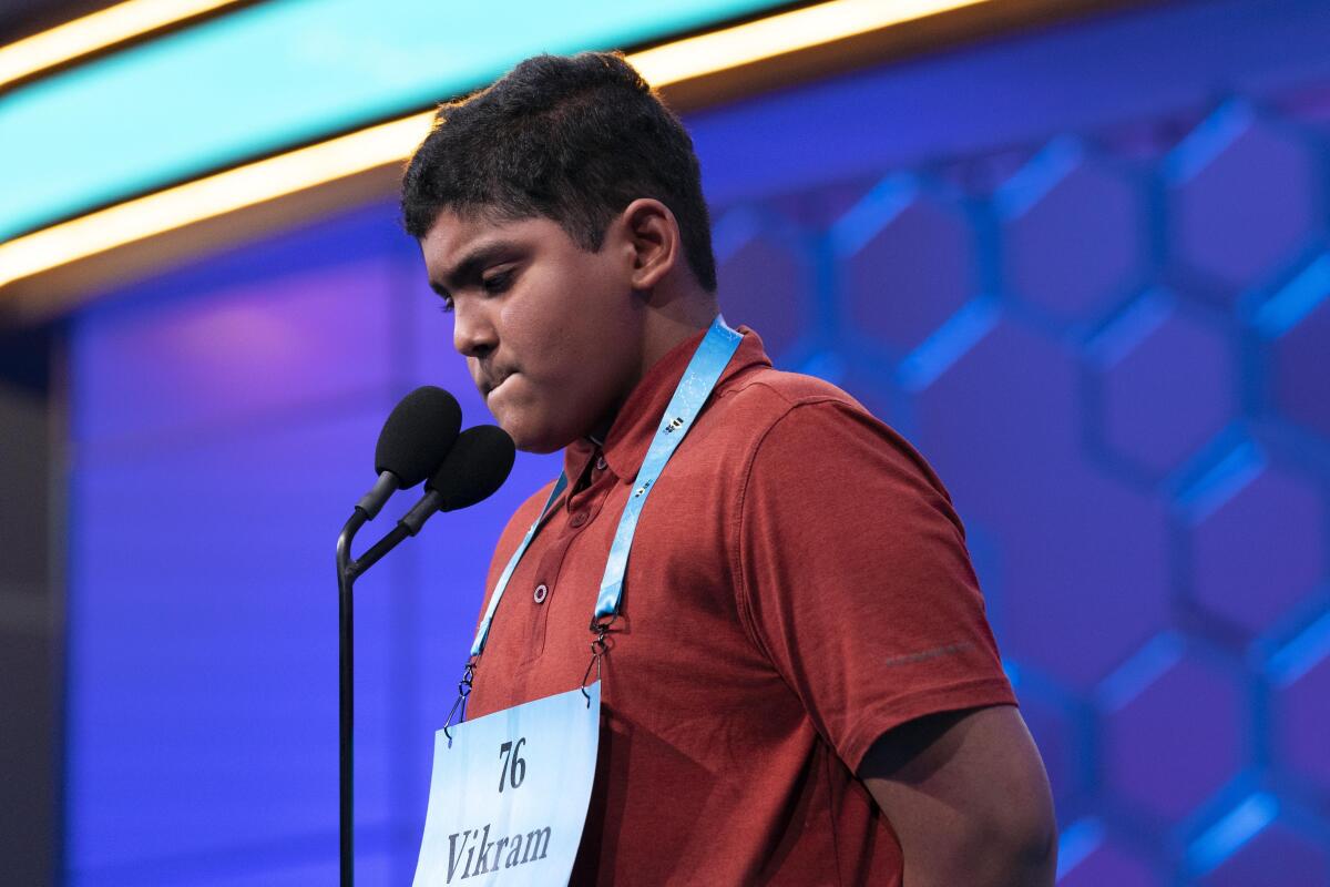 Boy onstage competing in the Scripps National Spelling Bee
