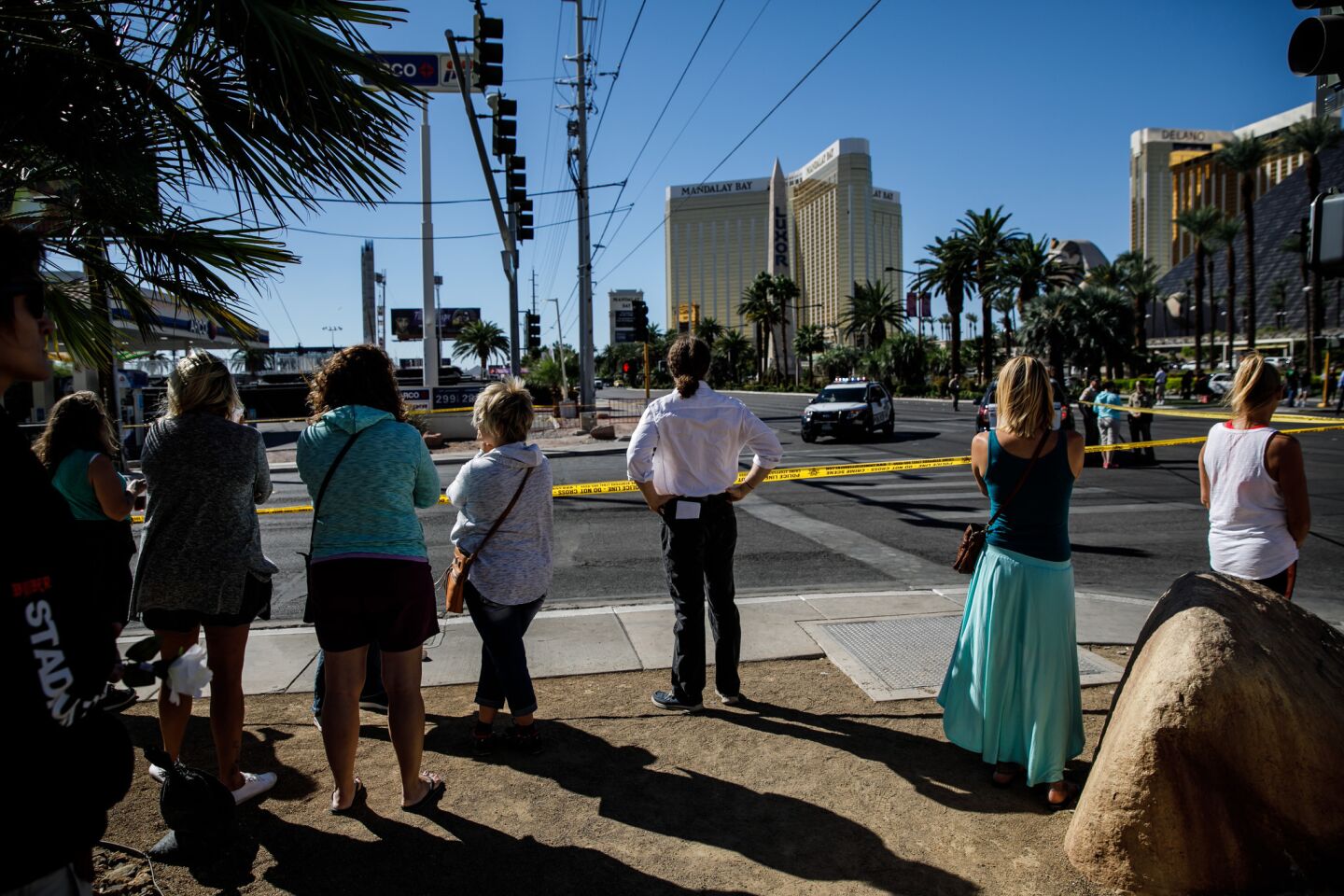 Tourists visit the crime scene, cordoned off by officials as the investigation of the mass shooting continues in Las Vegas.