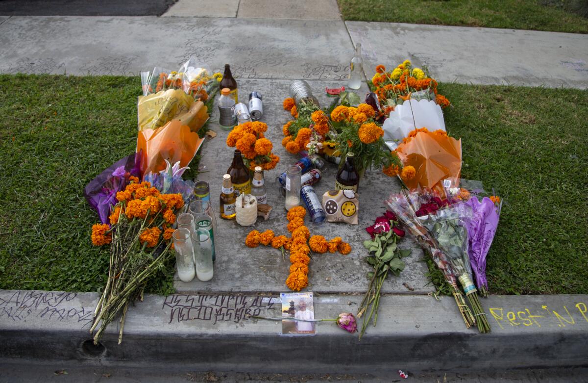 A memorial for Martin Chavez, 23, is in place on a sidewalk in Huntington Beach.