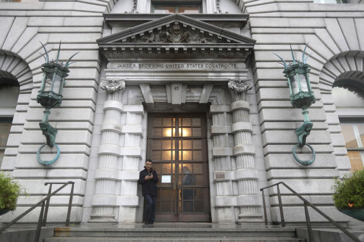 A man stands outside the U.S. 9th Circuit Court of Appeals building in San Francisco.