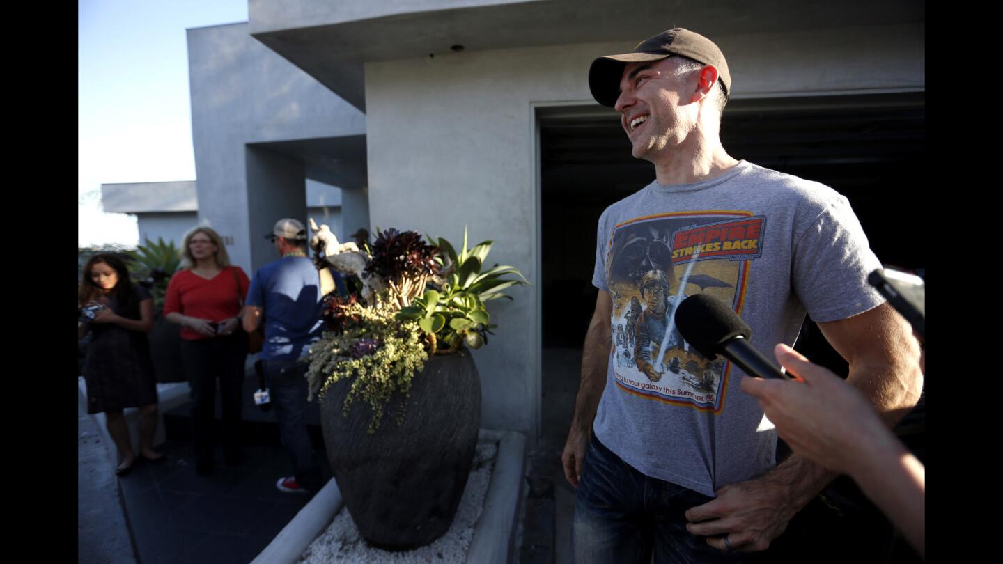 Homeowner Jason Archinaco talks with the media outside his home in the Los Feliz hills. Wildlife officials left Archinaco's home Monday night with the big cat still under the home.