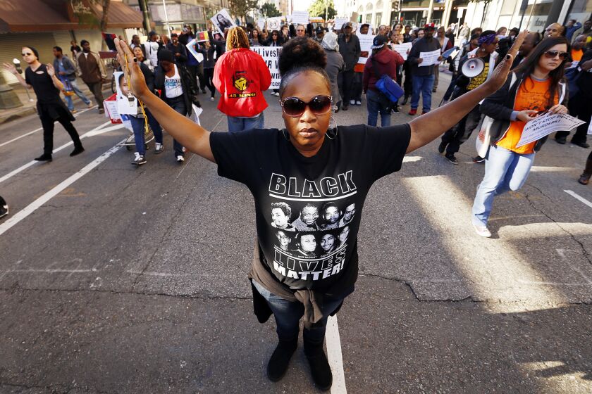 Protesters march on March 3 from the skid row site where a homeless man was killed by officers on March 1 to the headquarters of the Los Angeles Police Department.