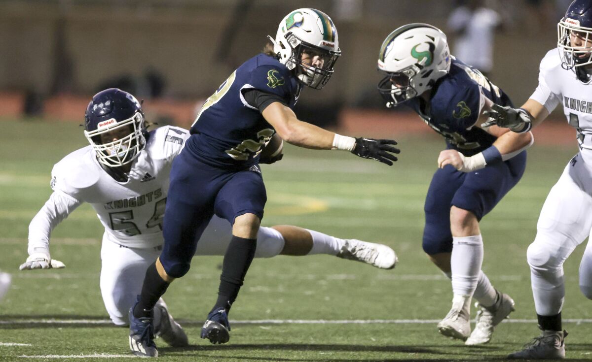 La Costa Canyon's Andrew Maes gets past San Marcos' Reid O'keefe to run for a touchdown during the first quarter.