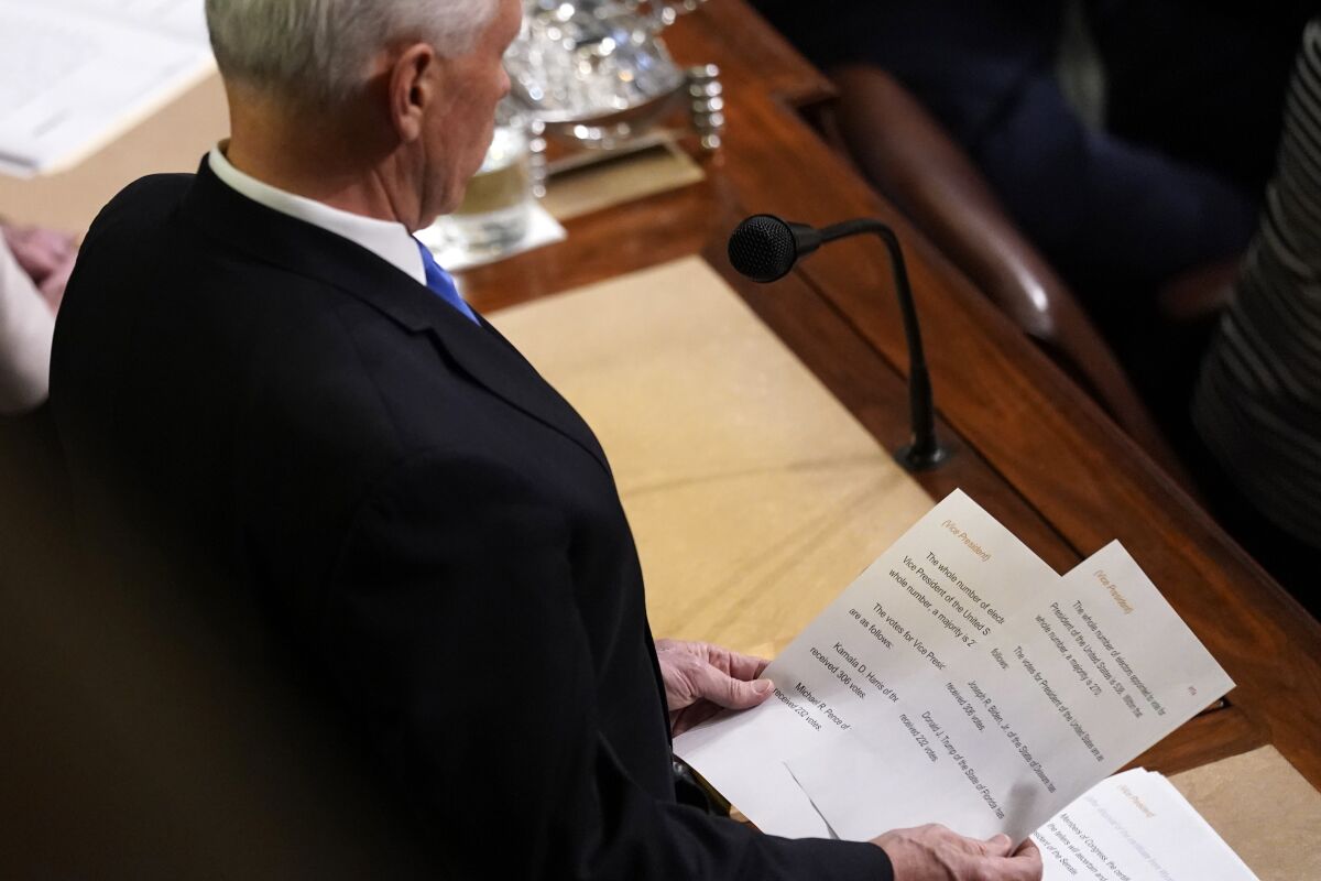 Vice President Mike Pence announces the election of President and Vice President as he officiates a joint session of the House and Senate to confirm Electoral College votes at the Capitol, early Thursday, Jan 7, 2021, in Washington. (AP Photo/Andrew Harnik)