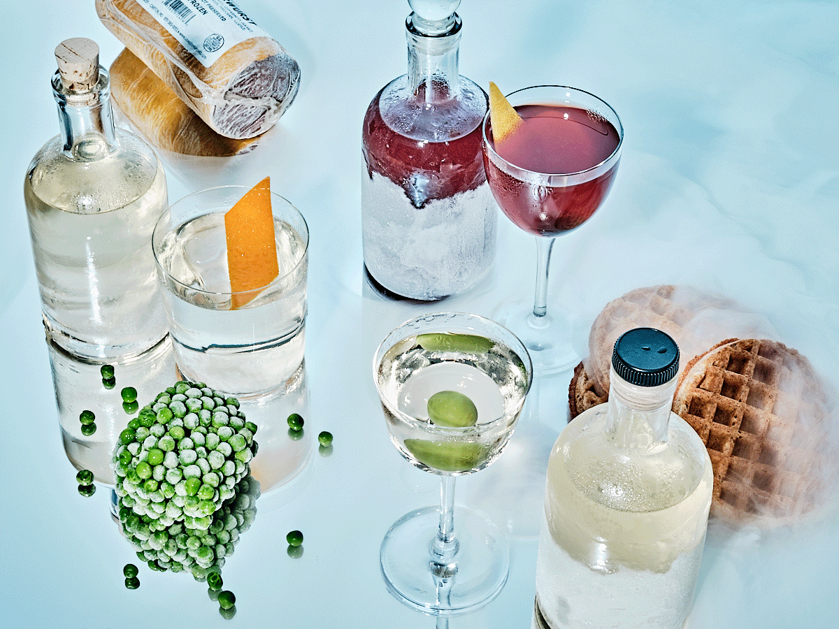 Cold air surrounds a display of frozen cocktails, frozen peas and frozen waffles.