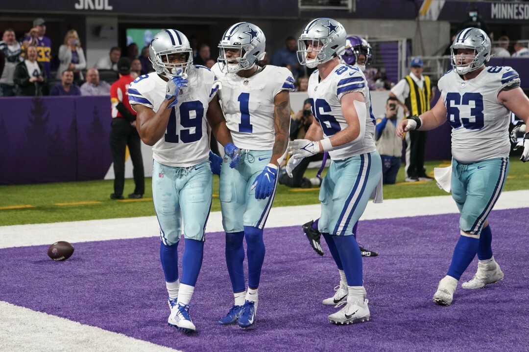 Dallas Cowboys wide receiver Amari Cooper celebrates with teammate Ced Wilson.