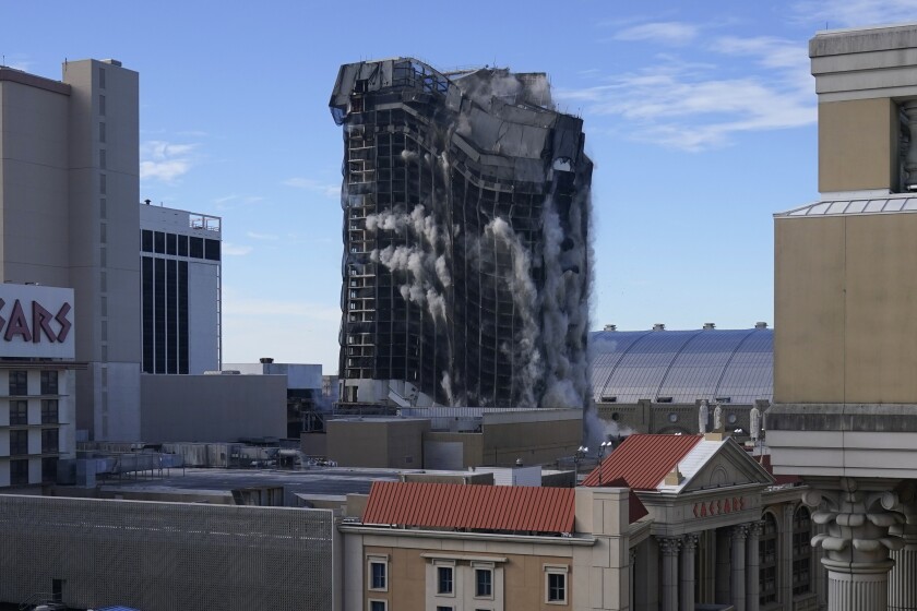 The main tower, left, of the former Trump Plaza casino in Atlantic City was imploded early Wednesday.