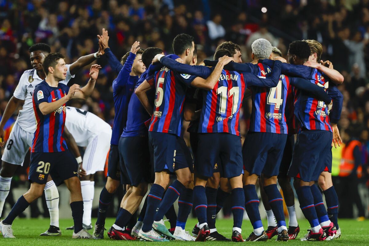 Barcelona's players celebrate at the end of the Spanish La Liga soccer match between Barcelona and Real Madrid at the Camp Nou stadium in Barcelona, Spain, Sunday, March 19, 2023. Barcelona won 2-1. (AP Photo/Joan Monfort)