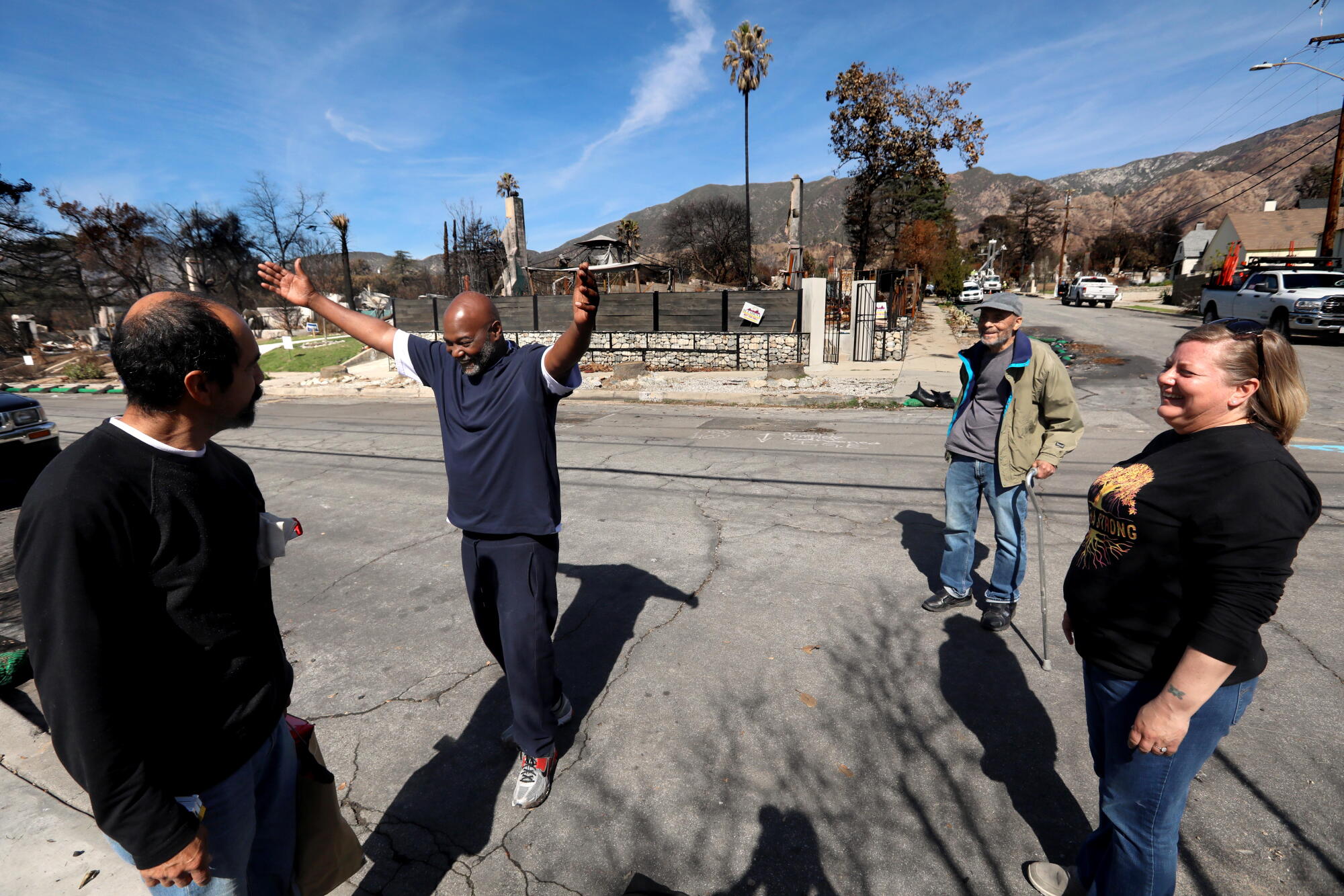 Neighbors share a moment along West Palm Street in Altadena.