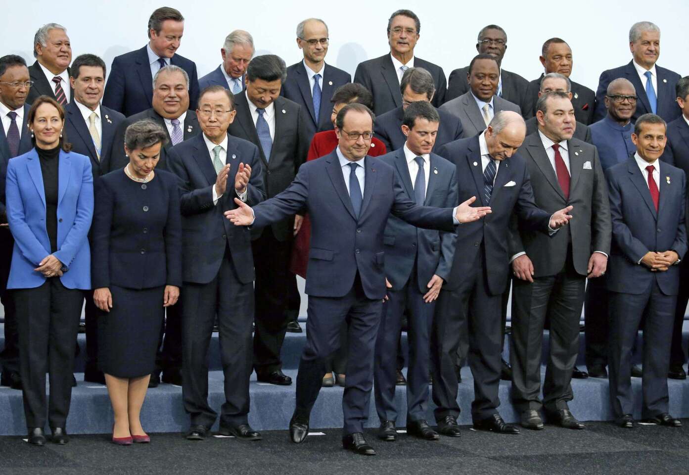 French President Francois Hollande gestures when posing with world leaders for a photo during the opening day of the World Climate Change Conference 2015 near Paris.