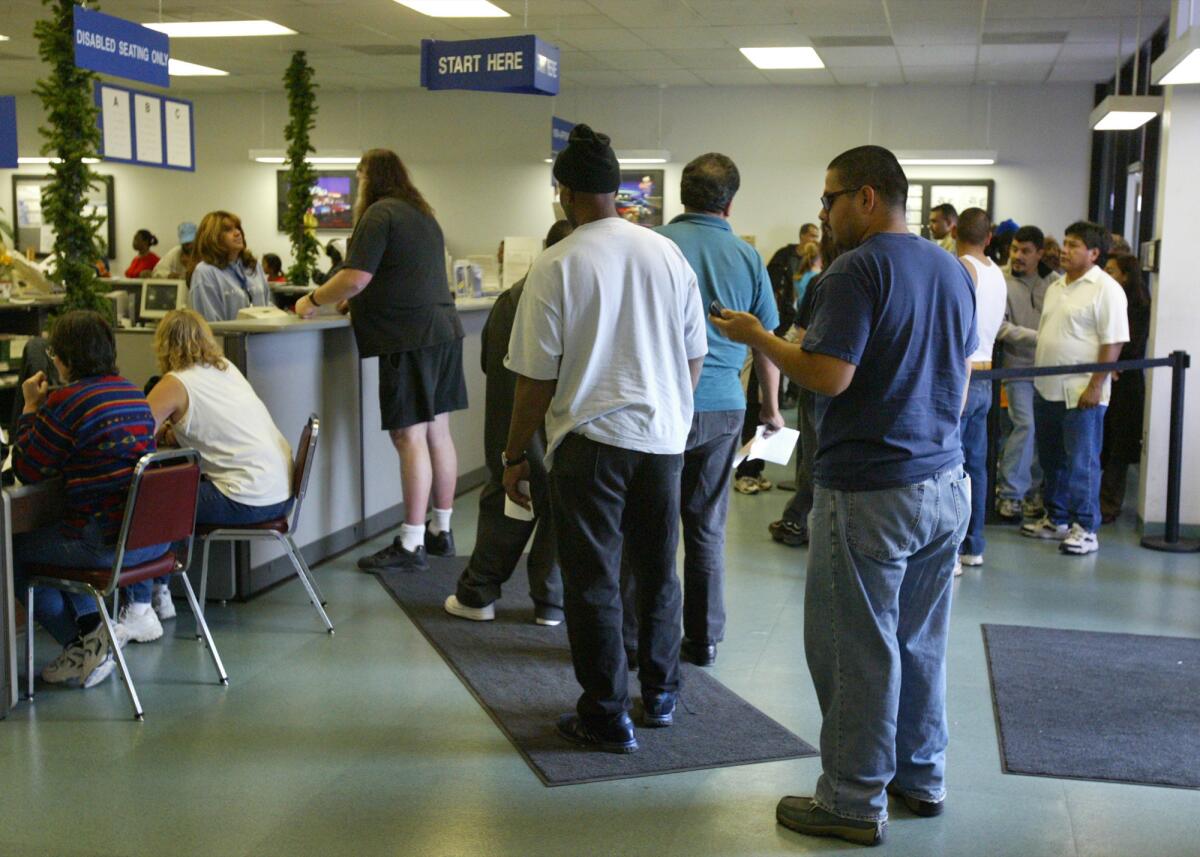 A DMV office in Palmdale with lines of people waiting for services.