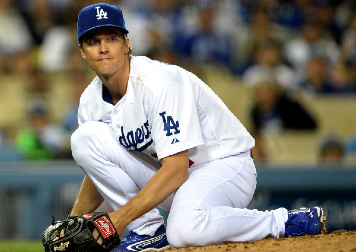 Dodgers right-hander Zack Greinke reacts to a hit by A.J. Pollock in the fifth inning Friday night. It was one of only three hits he surrendered in six innings.