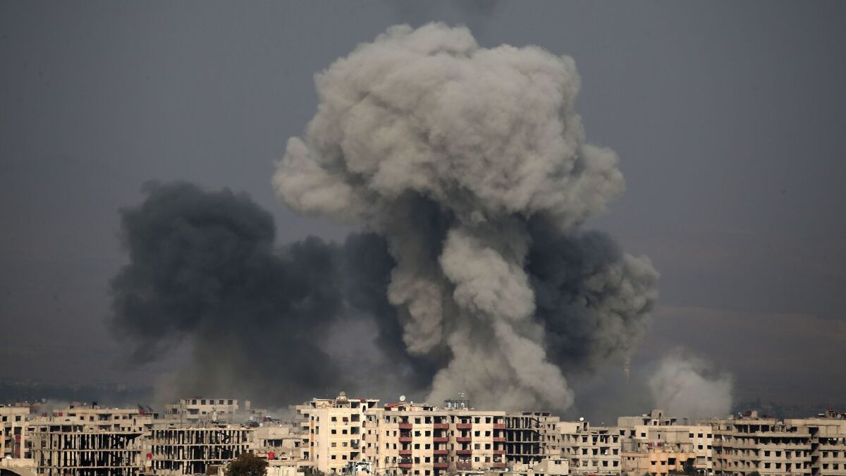 A picture taken on Feb. 20, 2018, shows plumes of smoke rising following a reported government airstrike in the rebel-held town of Hamouria, in the besieged east Ghouta region on the outskirts of the Syrian capital, Damascus.