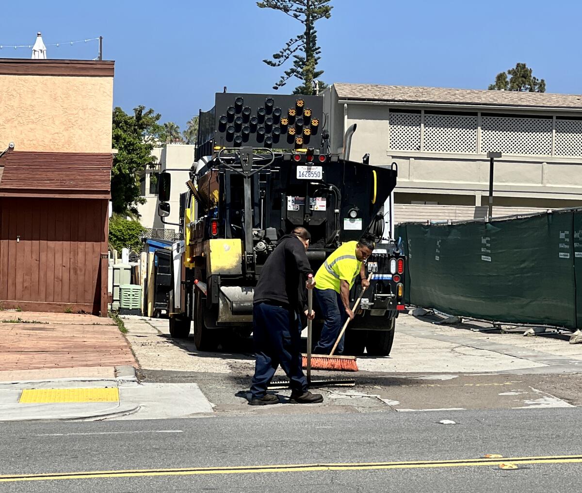 An alleyway undergoes pothole repair in La Jolla's Village.