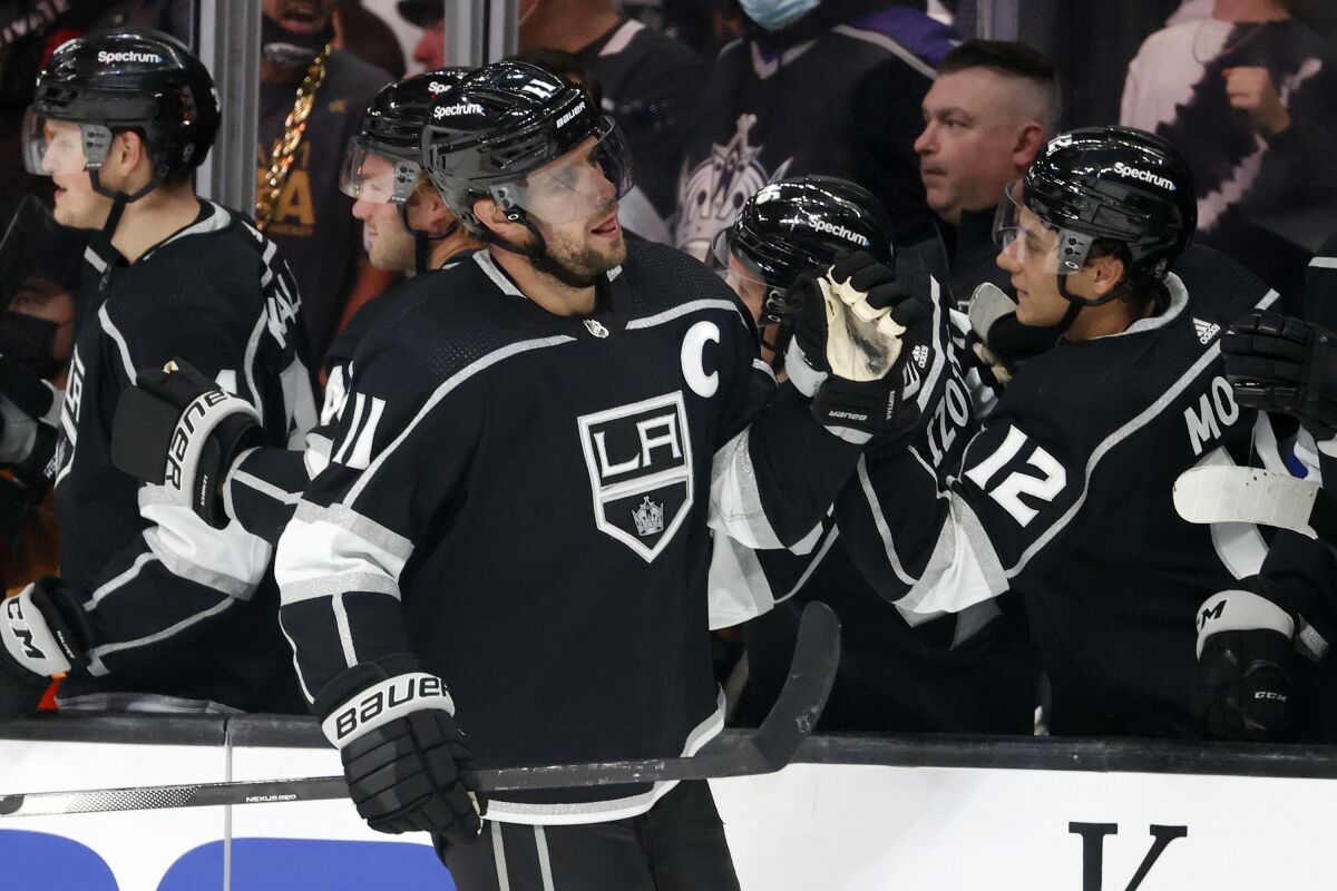 Los Angeles Kings forward Anze Kopitar (11) is congratulated on his goal against the Vegas Golden Knights during the first period of an NHL hockey game Thursday, Oct. 14, 2021, in Los Angeles. (AP Photo/Ringo H.W. Chiu)