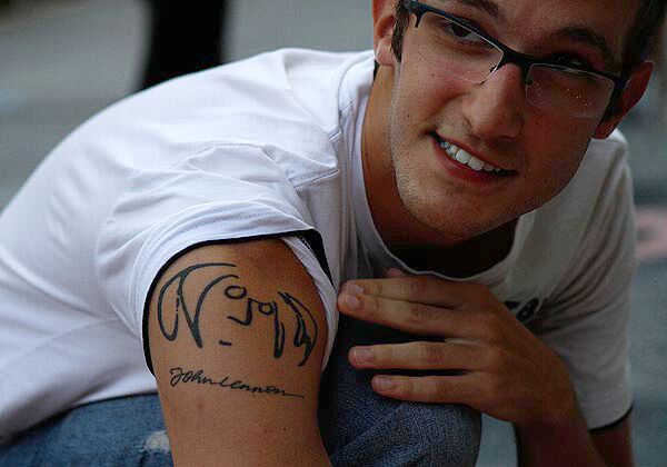 Romero of Brazil shows off his John Lennon tattoo