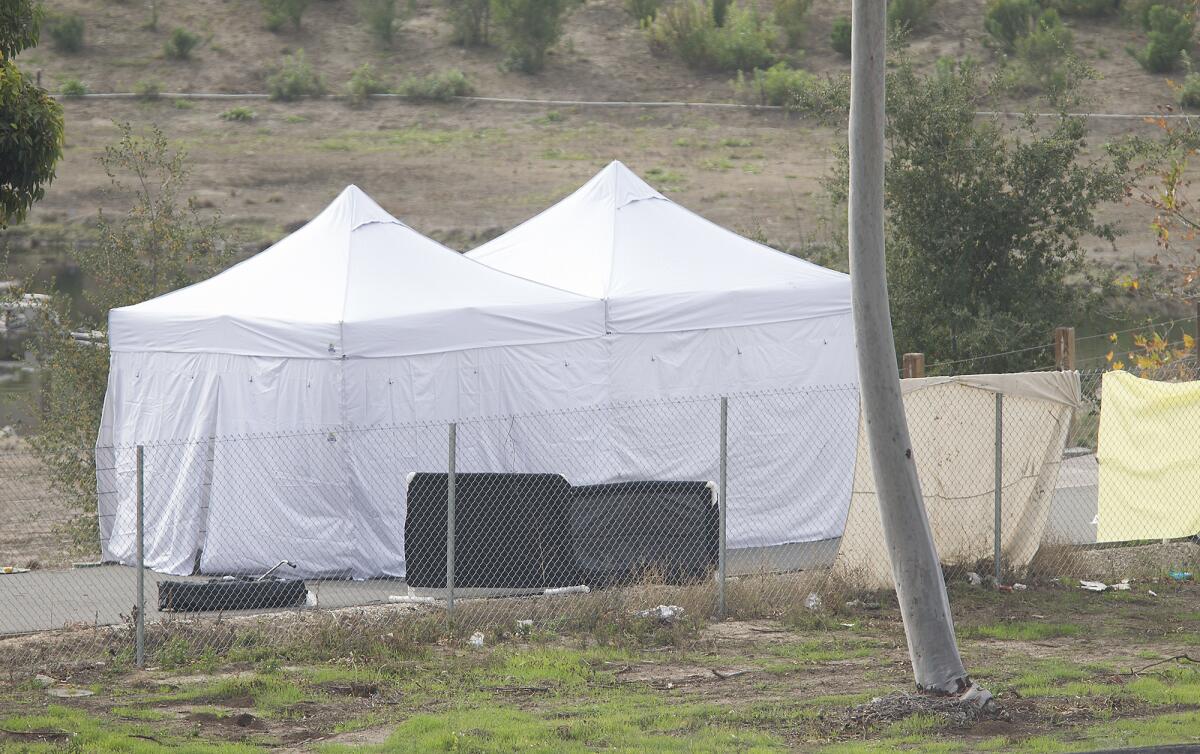 Tents mark the spot where a body was found Tuesday on a bike path next to the southbound 405 Freeway in Irvine.
