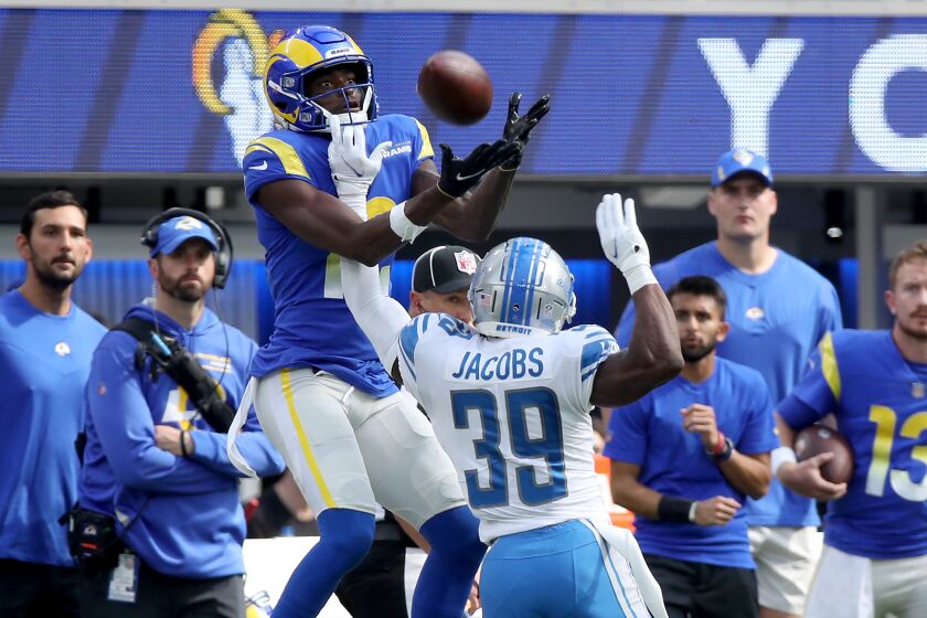 INGLEWOOD, CALIF. - OCT. 24, 2021. Rams wide receiver Van Jefferson goes up for a pass against Lions cornerback.
