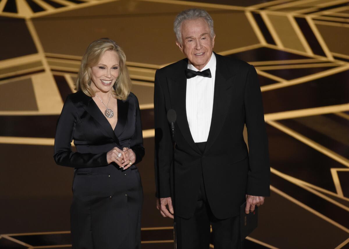 Faye Dunaway, left, and Warren Beatty present the award for best picture at the Oscars.